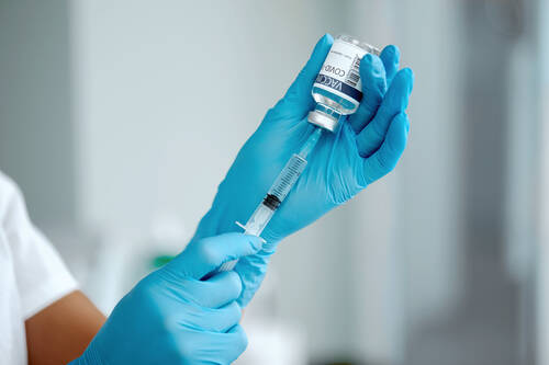 Woman doctor laboratory holding syringe with vaccines female holding covid19 vaccine hand